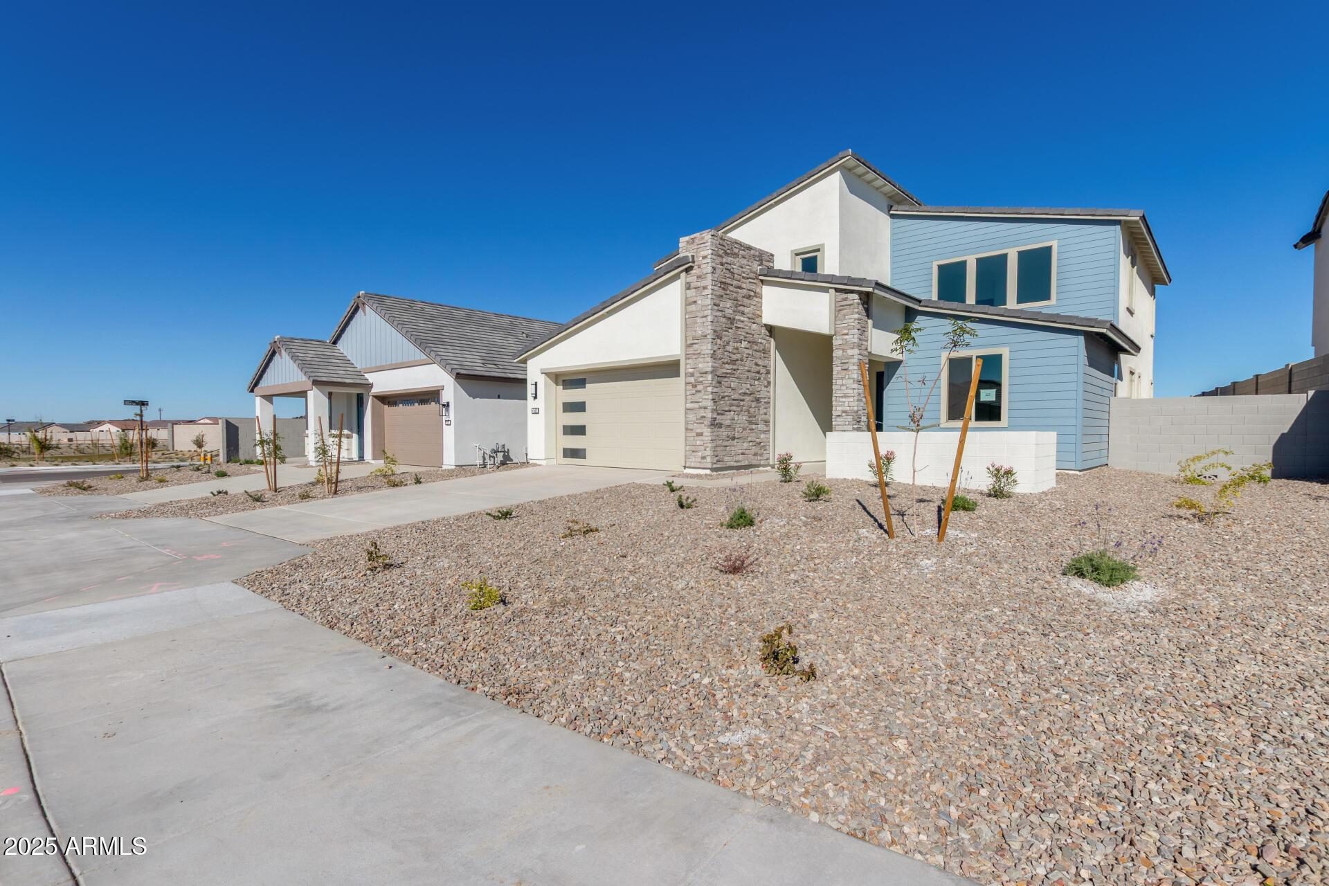 Street of new homes in Teravalis Buckeye AZ showing current real estate inventory in Floreo Village